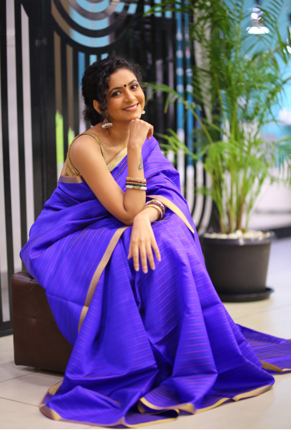 Lady in a handwoven bamboo silk saree in blue colour
